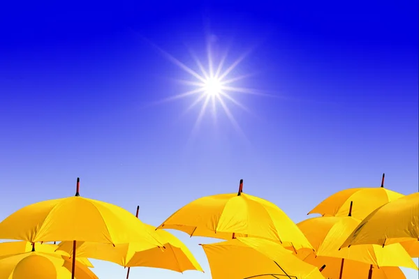 Yellow umbrellas on celestial background — Stock Photo, Image