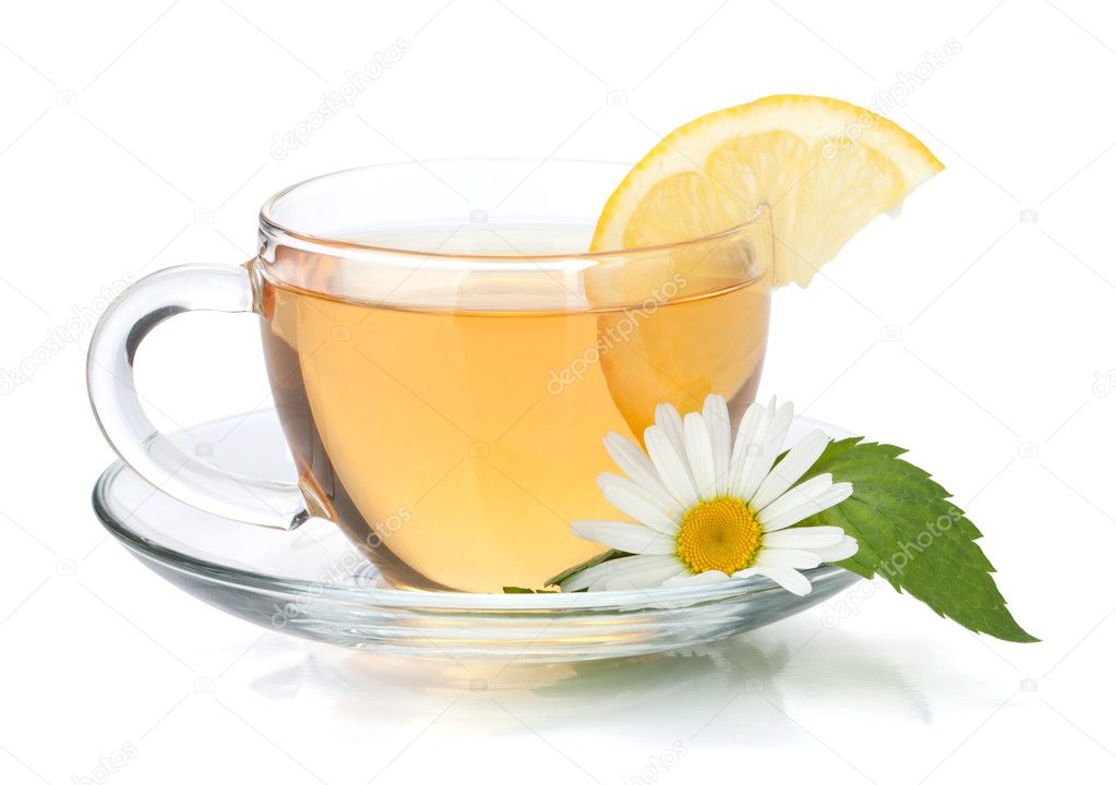 Cup of tea with lemon slice, mint leaves and chamomile flower