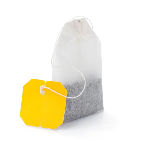 Teabag with yellow label — Stock Photo, Image