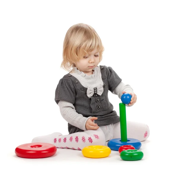 Baby girl with a toy pyramid — Stock Photo, Image