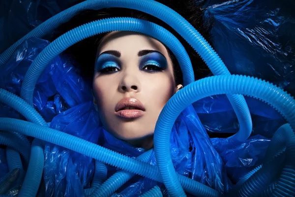 Futuristic beautiful young female face with blue fashion make-up. — Stock Photo, Image