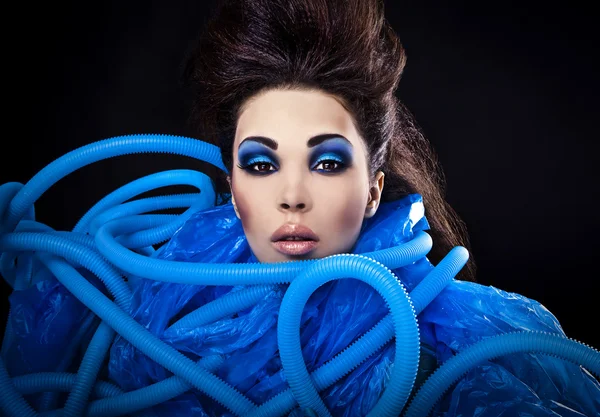 Futuristic beautiful young female face with blue fashion make-up. — Stock Photo, Image