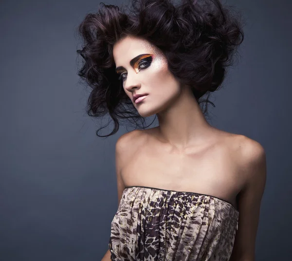 Beautiful young brunette female with bright fashion multicolored make-up. Studio photo. — Stock Photo, Image
