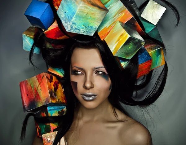 Fashion close-up portrait of beautiful young girl with cubes on head. Conceptual photo. — Stock Photo, Image