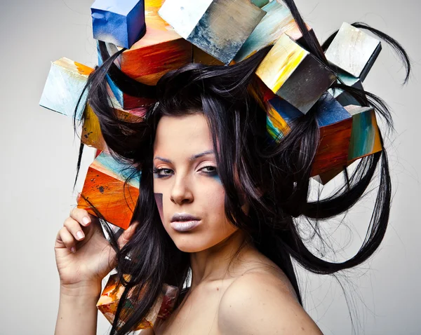 Fashion close-up portrait of beautiful young girl with cubes on head. Conceptual photo. — Stock Photo, Image