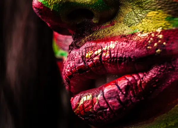 Close-up portrait of an artistic woman painted with red & green color. Part of face photo. — Stock Photo, Image