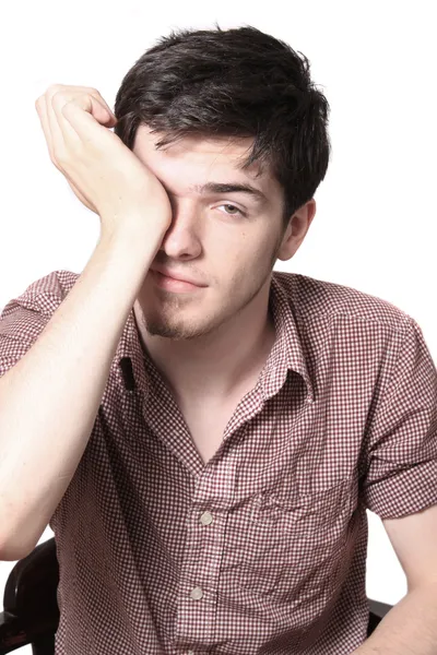 Tired male teen rubbing his eyes — Stock Photo, Image