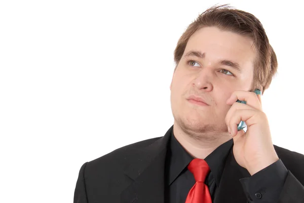 Young businessman in black formal suit talking on cellphone — Stock Photo, Image
