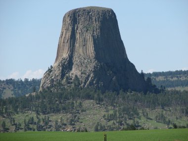 Devils Tower, Wyoming in evening light with blue sky clipart