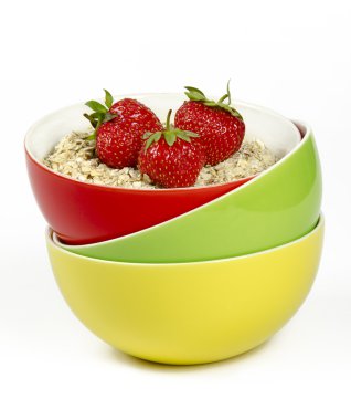 Bowls with oatmeal and fresh strawberries clipart