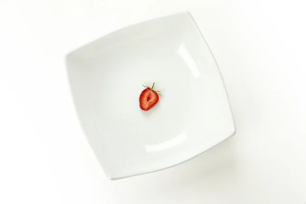 stock image Slice of strawberry on the white plate