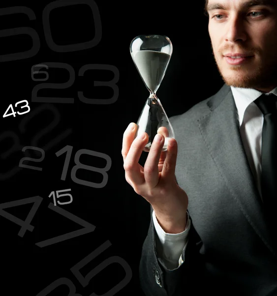 Businessman holding a hourglass — Stock Photo, Image