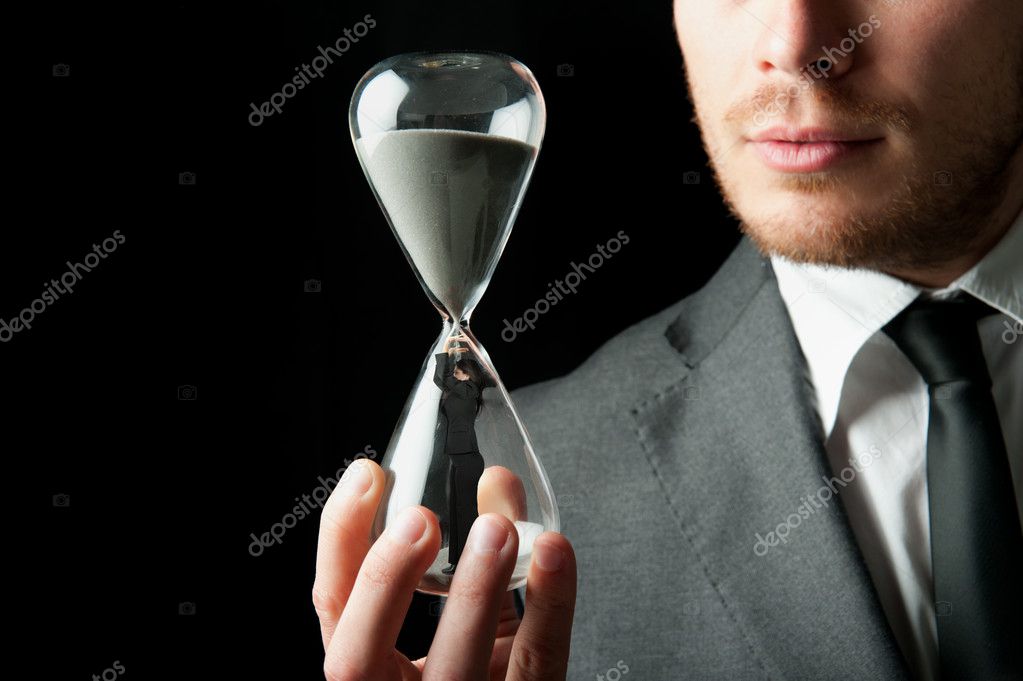 Businessman holding a hourglass with a girl inside
