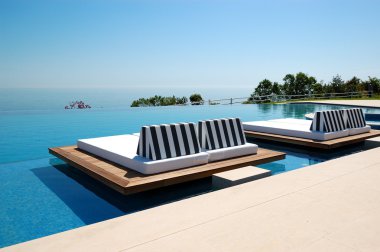 Infinity swimming pool by beach at the modern luxury hotel, Pier clipart