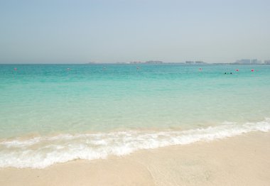 Beach of the luxury hotel with a view on Palm Jumeirah man-made clipart