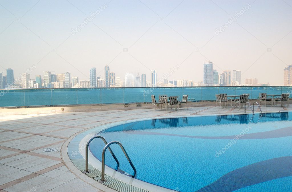 Swimming pool with Sharjah fountain and man-made lake view at th
