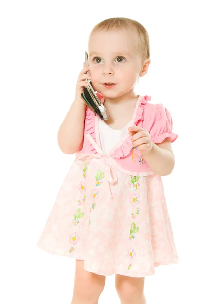 Kleines Mädchen telefoniert im rosa Kleid — Stockfoto