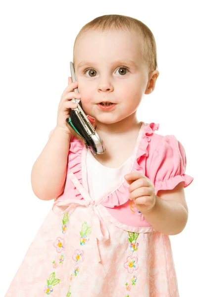 Küçük kız pembe elbise giymiş telefonda konuşurken — Stok fotoğraf