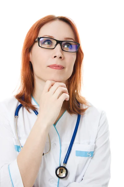 Μια γυναίκα γιατρός σκέφτεται ένα λευκό φόντο. — Φωτογραφία Αρχείου
