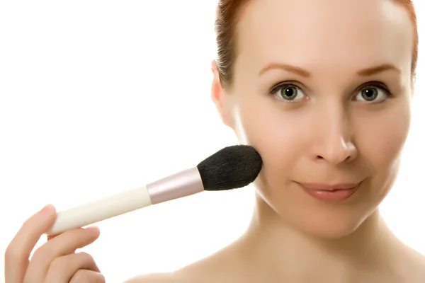 Beautiful woman with makeup brush near her face — Stock Photo, Image