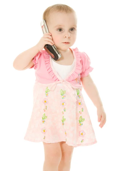 Niña hablando por teléfono en un vestido rosa — Foto de Stock