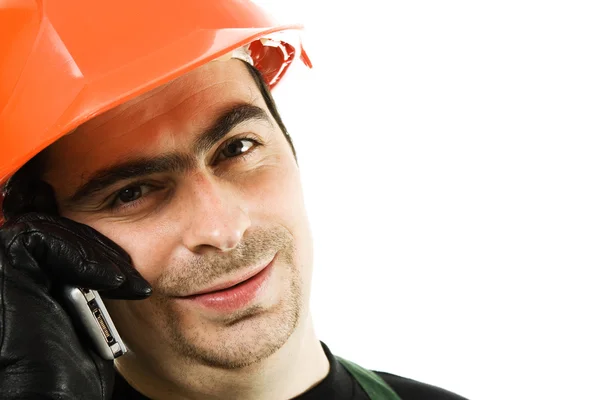 Male architect in a hardhat talks by a mobile phone — Stock Photo, Image