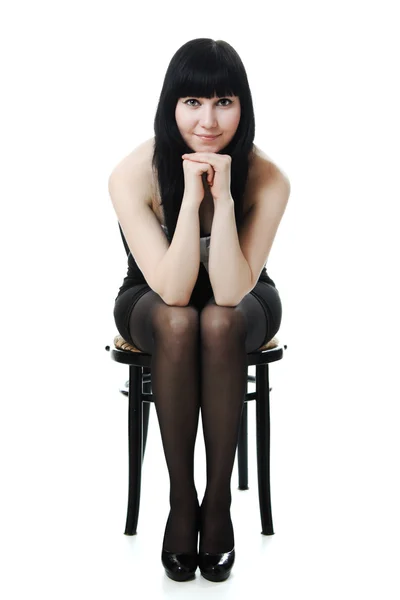 Sure beautiful woman in evening dress on a chair — Stock Photo, Image
