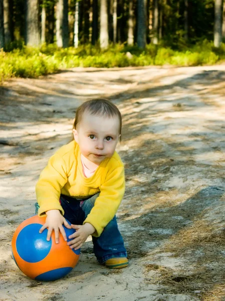 Little baby plays with ball — Stock Photo, Image