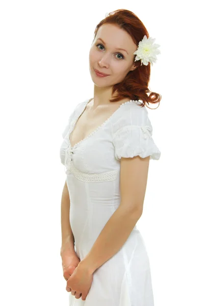 Υγιές δέρμα του προσώπου νεαρή και όμορφη γυναίκα με ένα λουλούδι στο της τρίχες σε λευκό φόντο. — Φωτογραφία Αρχείου