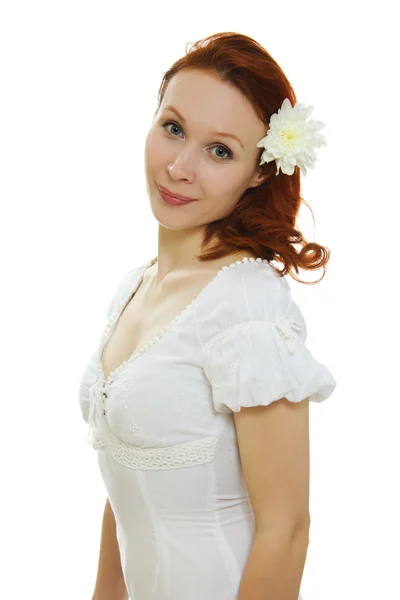 Healthy skin of young beautiful woman face with a flower in her hairs on a white background. — Stock Photo, Image