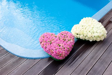 Flower hearts near swimmong pool clipart