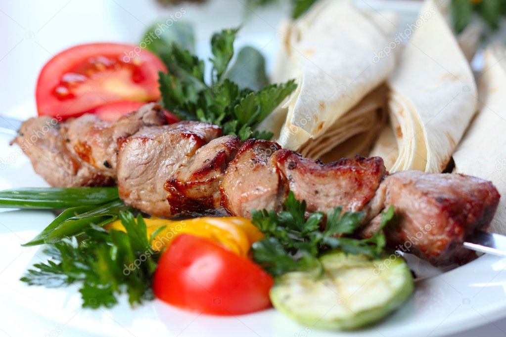Shish pork kebab with greens and vegetables