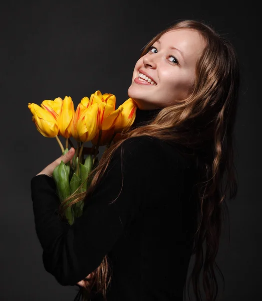 Happy blond woman with tulips — Stock Photo, Image