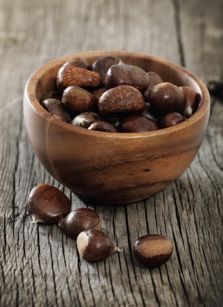 Roasted chestnuts on wooden background — Stock Photo, Image