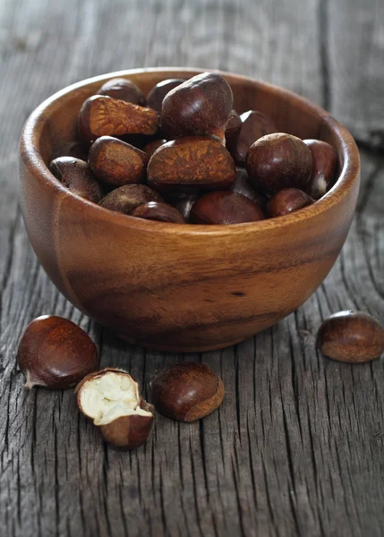 Roasted chestnuts on wooden background — Stock Photo, Image
