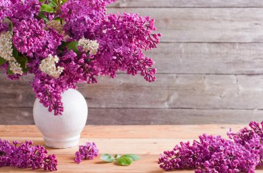 The beautiful lilac on a wooden background clipart