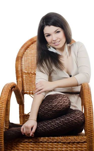 The beautiful girl in wicker chair — Stock Photo, Image