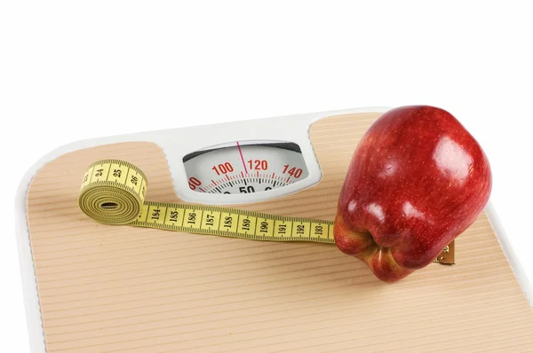 Scale, tape and apple on white — Stock Photo, Image