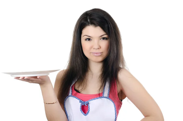 The girl in an apron holds a plate — Stock Photo, Image