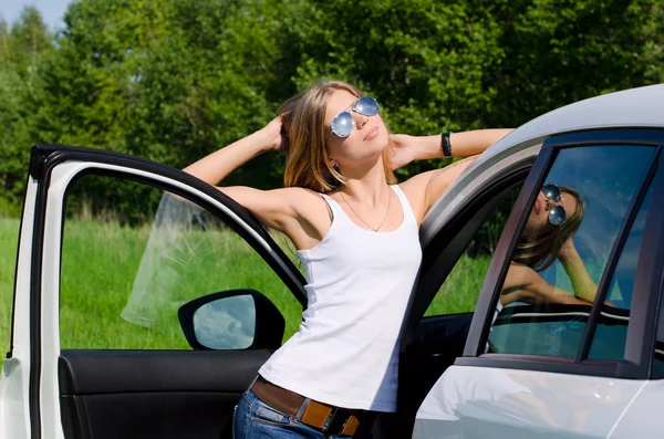 Den vackra flickan står nära vit bil — Stockfoto
