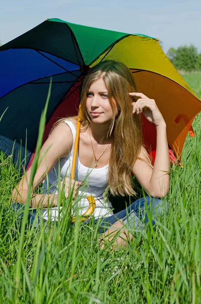 Beautiful girl with a multi-coloured umbrella — Stock Photo, Image