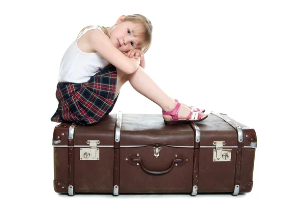 The little girl on old suitcases — Stock Photo, Image
