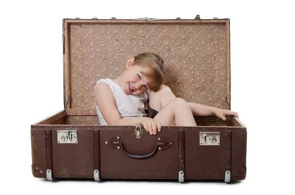 Das kleine Mädchen in einem alten Koffer isoliert — Stockfoto