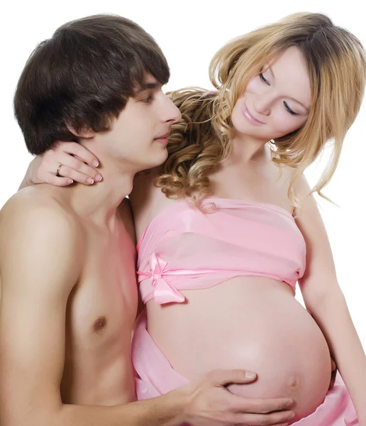 Счастливая беременная пара изолированы на белом Стоковая Картинка