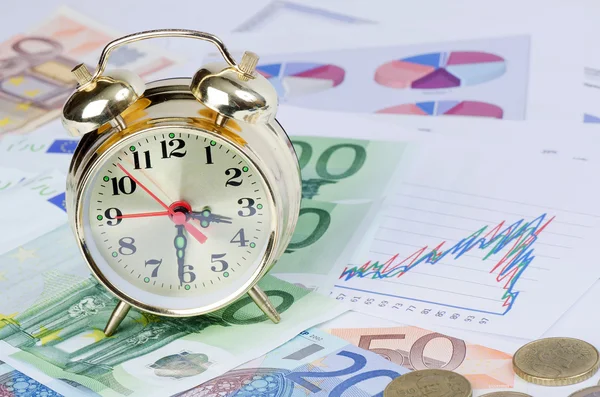 stock image Alarm clock for euro banknotes as a background