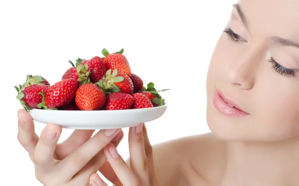 The beautiful woman with a strawberry — Stock Photo, Image