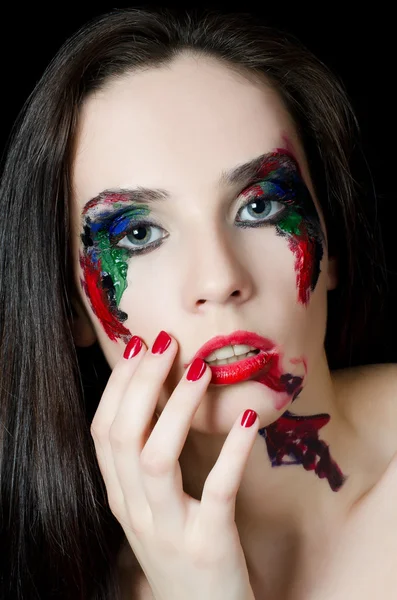 The beautiful woman with a paint on the face — Stock Photo, Image