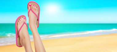 Pink sandals on woman legs. Summer time concept clipart