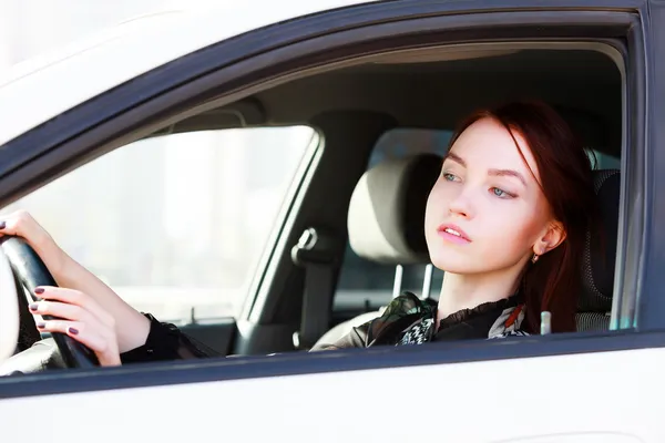 Girl looking in rear view mirror — Stock Photo, Image