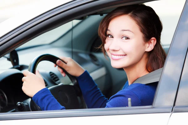 Happy female driver smiling to you — Stock Photo, Image